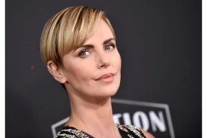 Charlize Theron Stuns in Micro Miniskirt at Paris Fashion Week